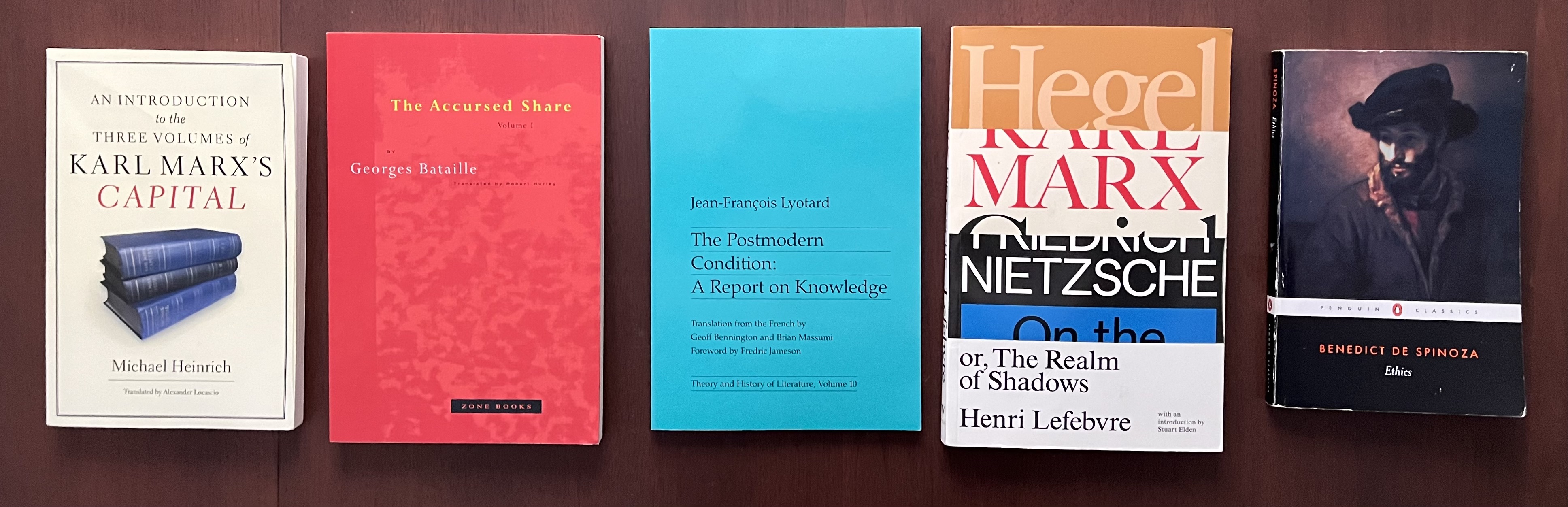 five books arranged on a table